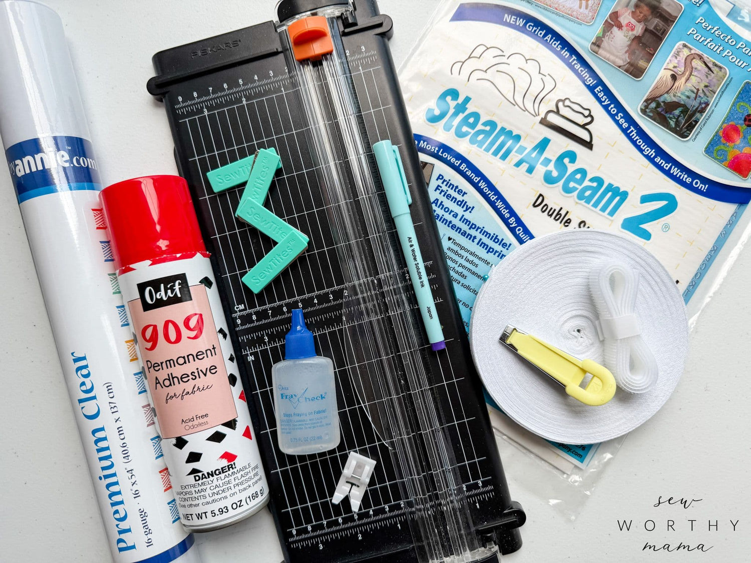 Sewing pattern PDF with cutting mat, ruler, and adhesive tape on work surface